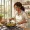 Woman with warm brown skin preparing a colourful meal in a bright kitchen